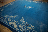 Pictorial floral vinery border and rich blue field texture of a vintage Peking carpet.
