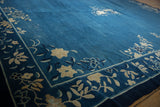 Hand-knotted vintage Peking carpet detail: indigo blue border with ivory floral vinery.