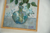 Artist Grace B. Keogh's purple GBK signature on the painting, framed in light wood.