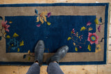 Vintage Art Deco runner with asymmetric blossoms, sapphire blue field and oxidized silver border.