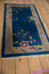 Art Deco rug corner, sapphire blue field, pink blossoms, saffron leaves, oxidized silver border.