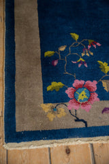 Sapphire blue field with blush blossom, saffron leaves, oxidized silver border, and intact selvage.