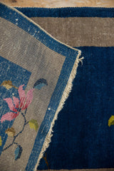Vintage Art Deco rug's oxidized silver hand-knotted foundation and original sapphire blue selvage.