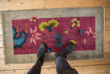 Burgundy field Nichols Art Deco rug, vibrant pink, lime green, navy floral motifs.