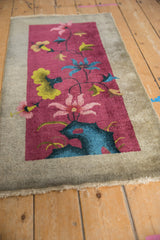 Art Deco runner corner shows burgundy field, blue mountaintop pictorial, delicate floral vinery.