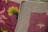 Art Deco rug's hand-knotted construction, showing textured pile and woven foundation.