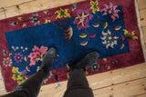 Corner of vintage Art Deco runner, indigo field, burgundy border, intact selvage.