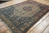 Intricate Herati design motif and inverted ground coloration on an antique Senneh rug.