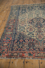 Hand knotted antique Senneh rug border: navy, red finned floral, with tattered side.