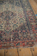 Antique Senneh rug with navy Herati design on ivory ground, dusty blush geometric border.