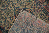 Antique Senneh Herati patterned rug, visible pile wear, and intricate hand-knotted foundation reverse.