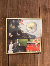 By the Edge of the Black Forest mixed media art shown at an angle in its light-colored frame.