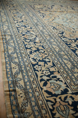 Navy and beige scrolling blossoms on vintage Doroksh border, intact selvage, faint foundation.