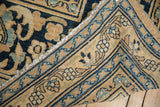 Detail of vintage Doroksh carpet: gold geometric border and deep blue floral ground.