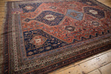 Qashqai rug border with geometric hook-and-latch motifs in navy, madder root red, and sky blue.