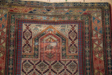 Daghestan rug's traditional prayer motif with weaver dates and primitive geometric borders.