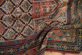 Antique Daghestan rug's intricate geometric borders and checkered lilies in navy, red, and ivory.