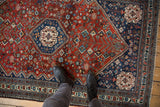 Intricate tree of life and floral motifs with visible abrashes on a vintage Abadeh rug.