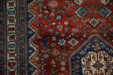 Detailed view of the fine Abadeh rug's intricate floral border and deep red geometric field.