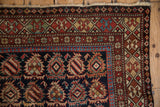Antique Caucasian rug corner, displaying geometric crab and pawn motif borders, madder root rust.