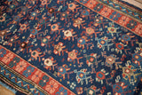 Antique Caucasian rug, abrashed cobalt blue field with geometric pomegranates, blossoms, and red floral border.