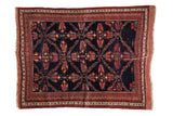 Antique Persian Afshar rug with an unusual lattice design of red and blue palmettes on a navy ground.