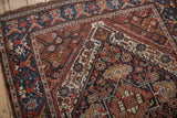Kamseh rug detail with dragon style main border, geometric patterns, navy, chestnut, ivory.