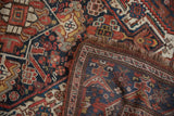 Geometric dragon border and field motifs of the vintage Kamseh rug, with visible pile.
