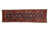 Antique Caucasian rug runner with a geometric blue field and a wide, colorful palmette and blossom border.
