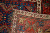 Reverse view of an antique Caucasian runner showing its hand-knotted crab palmette border.