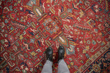 Worn pile of a vintage Gorevan carpet, showing tiered floral pattern in red, navy, gold.