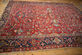 Vintage Gorevan carpet end showing cherry red field, floral patterns, navy border, and even wear.
