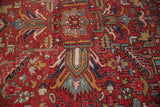 Cherry red field of vintage Gorevan carpet with germinating floral cross-sections and serrated leaves.