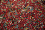 Gorevan carpet displays multi-tiered floral cross-sections and elongated leaves on a cherry red field.