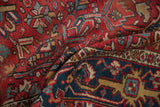 Vintage Persian Gorevan carpet: folded texture, showing germinating floral motifs in cherry red and navy.
