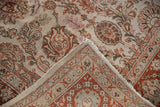 Distressed floral pile showing knot heads and the woven foundation of a vintage Persian carpet.