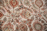 Intricate floral sprays and palmettes on the textured pile of a vintage distressed Meshed carpet.