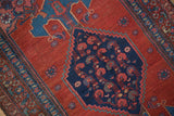 Detail of the hand-knotted Herati design inside the navy blue medallion of a vintage Kurdish Bijar rug.