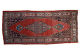 Antique Halvai Bijar runner, cherry red field, deep blue stepped medallion, late 19th century.