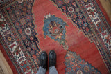 Antique Halvai Bijar rug's stepped medallion, palmettes, abrash ruby red field, and sky blue motifs.