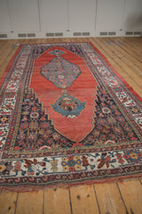 Antique Halvai Bijar rug: stepped red abrashed field, intricate dark and cream floral borders.