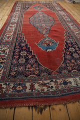 Intricate border, corner spandrel, and rewoven signature panel on the antique Halvai Bijar rug.
