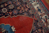 Antique Halvai Bijar rug showing a patch repair on its cherry red field.