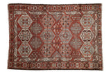 Distressed vintage Baktiari rug with an allover geometric design in chestnut, silver, and dusty rose.
