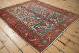 Antique Malayer rug's allover geometric pattern and square shape, viewed from a high corner angle.