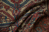 Rich texture of a draped antique Malayer rug with serrated motifs in red, blue, and ivory.