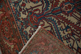 Folded corner of an antique Malayer rug revealing the fine hand-knotted back and intact selvage.