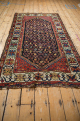 Close-up of vintage Kurdish Hamadan rug, showing crab style floral border and geometric boteh field.
