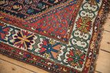 Ornate crab style floral border and dark shaggy fringe of a vintage Kurdish Hamadan.