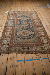 Geometric Vintage Caucasian rug, navy field, central medallion, mahi-mahi, birds, and visible pile wear.